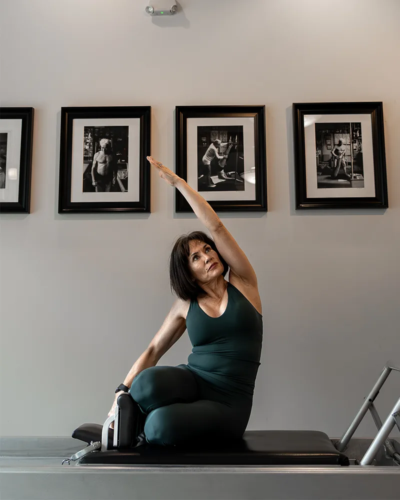 Award-recognized Pilates instructor guiding one-on-one classical Pilates session for strength and mobility